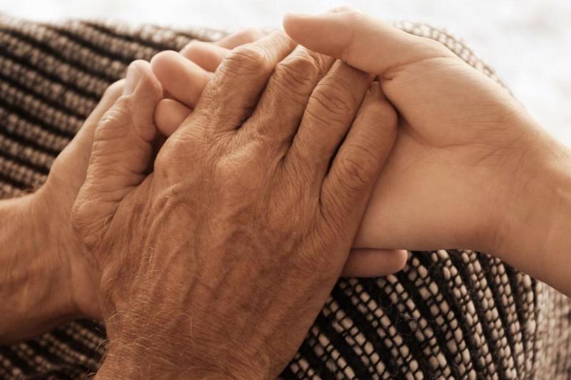 older hands and younger hands holding each other
